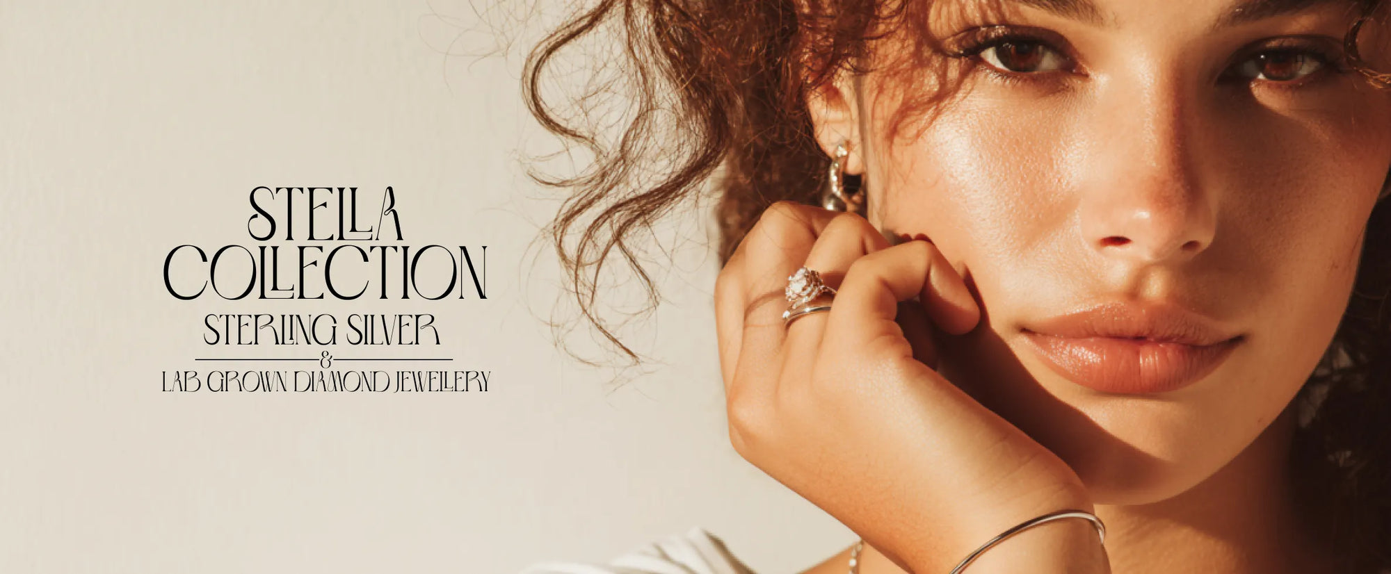 Woman wearing earrings with 'Stella Collection' text on a light background