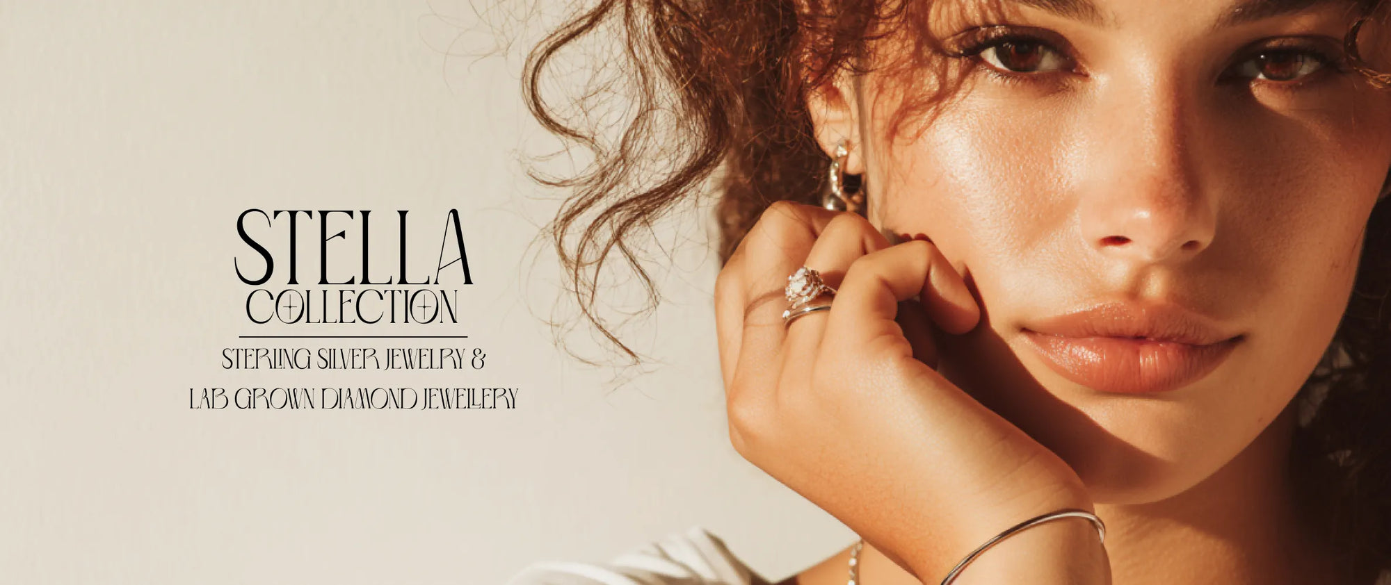 Woman adjusting earrings with 'Stella Collection' text on a light background
